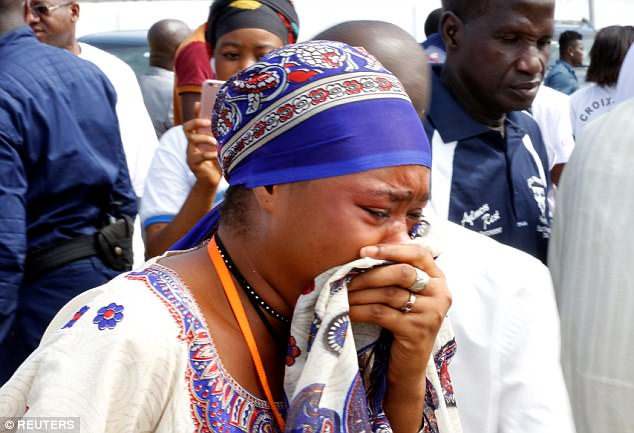 A family member shows their grief at the service as mourners turned up to pay their respects