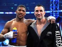 Anthony Joshua stands with Wladimir Klitschko following the IBF, WBA and IBO Heavyweight World Title bout