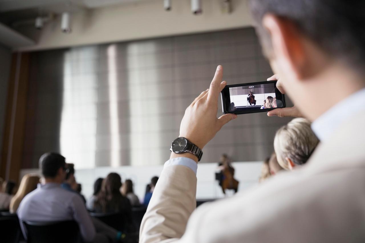 Whilst filming, use the white button in the corner of the screen to take stills